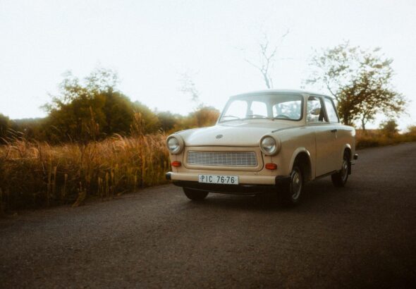 an old car is parked on the side of the road